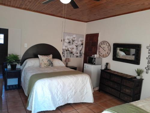a bedroom with a bed and a clock on the wall at Pumba's B&B in Sannieshof