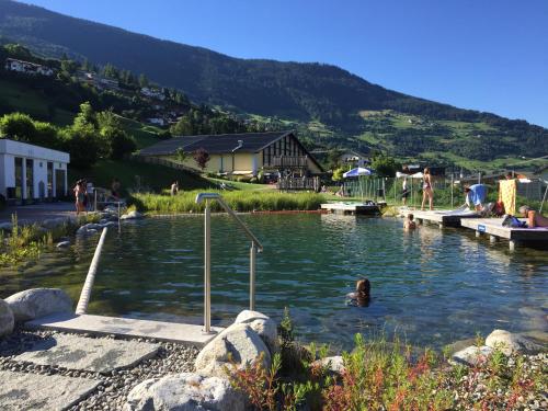 a pool with a teddy bear in the water at Gschlössle Ferienwohnungen in Jerzens