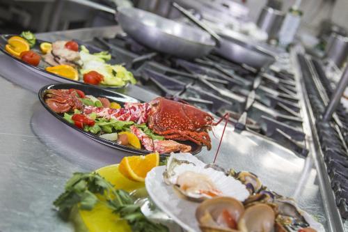 a table with two plates of food on a stove at Hotel Mara in Ortona