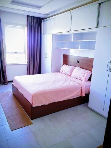 a bedroom with a large bed and a window at Residence el michouar in Laayoune