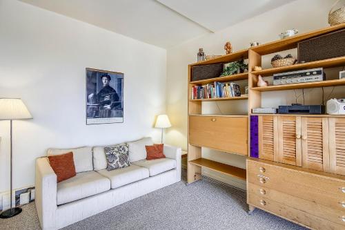 a living room with a couch and a book shelf at Notchbrook 28AB in Stowe