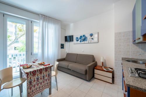 a living room with a couch and a table at Aparthotel Pineda in Bibione