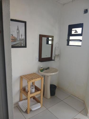 a bathroom with a sink and a mirror at Pousada Costeira Barra do Sul in Balneario Barra do Sul