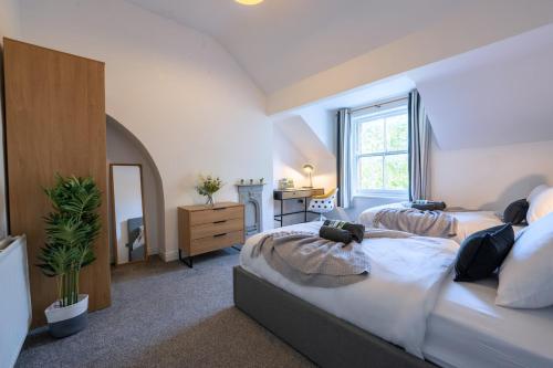 a bedroom with two beds and a mirror at The Lytham Retreat - New! Spacious & Luxurious in Lytham St Annes