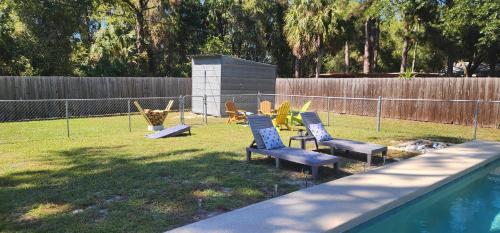 a group of chairs in a yard next to a pool at Crystal Blue Haven in Crystal River