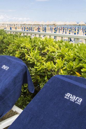 a blue towel sitting on a table next to a hedge at Hotel Mara in Ortona