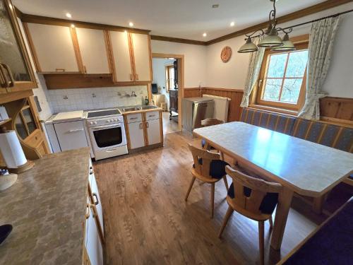 a kitchen with a wooden table and a dining room at Ferienwohnung WIEKI in Puchreit