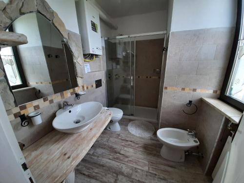 a bathroom with a sink and a toilet and a shower at Villa Finetti in Gubbio