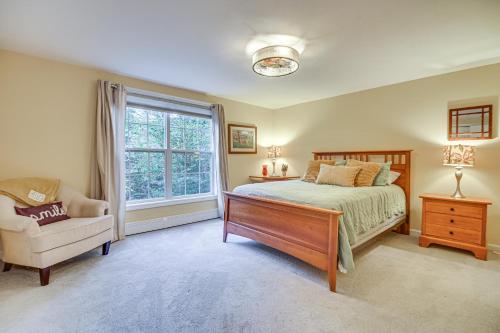 a bedroom with a bed and a chair and a window at Pet-Friendly Home with Hot Tub Near Cranmore! in Conway