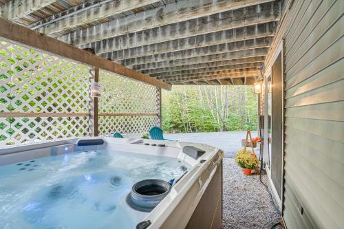 a hot tub in the backyard of a house at Pet-Friendly Home with Hot Tub Near Cranmore! in Conway