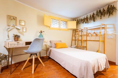 a bedroom with a bed and a desk and a chair at En las montañas de Benicassim in Las Villas