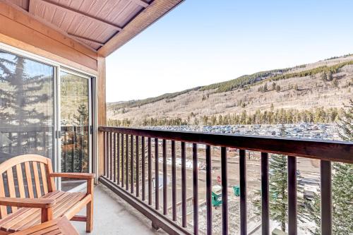 a balcony with a chair and a view of a mountain at Buffalo Lodge 8351 in Keystone