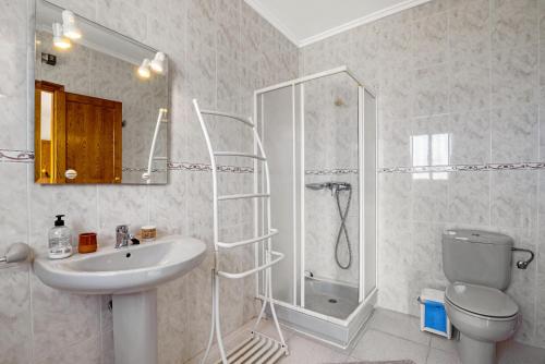 a bathroom with a shower and a sink and a toilet at Tossal Gros in La Font D´En Carròs