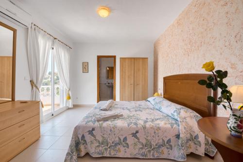 a bedroom with a bed and a table and a window at Tossal Gros in La Font D´En Carròs