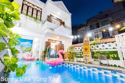 a swimming pool with pink flamingos in a hotel at Sunny Villa 109 Võ Thị Sáu in Vung Tau