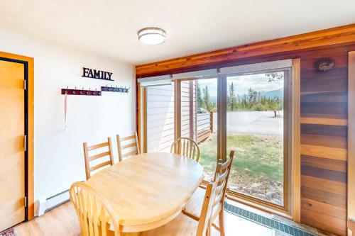 a dining room with a table and chairs and a window at Timber Ridge 203 in Silverthorne