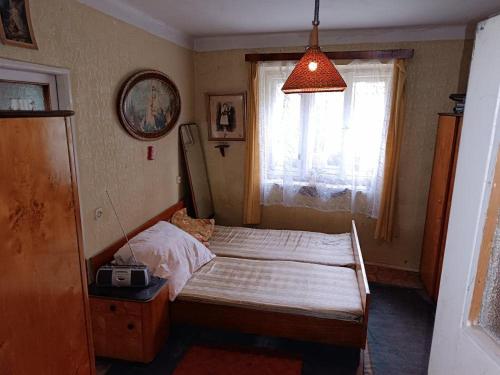 a small bedroom with a bed and a window at biofarma in Chrudim
