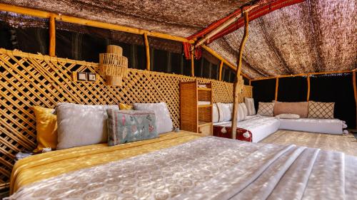 a bedroom with a bed in a tent at Berber Beldi Camp in Imsouane
