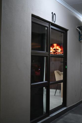 an open window with a fire in a fireplace at Solo Apartments in Maun