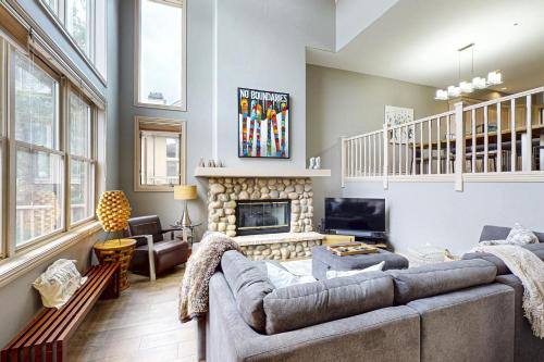 a living room with a couch and a fireplace at Ironwood 16 in Steamboat Springs