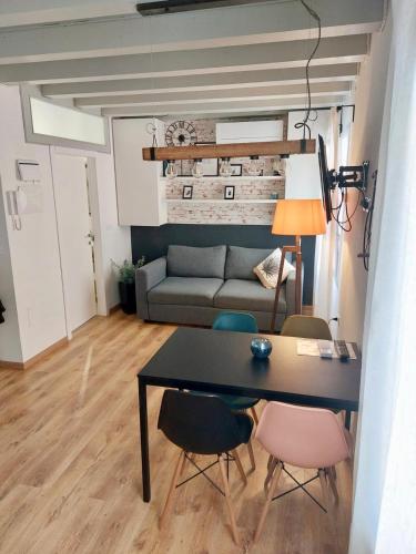 a living room with a table and chairs and a couch at Sepa in Chioggia