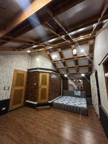 an empty room with a bed in a brick wall at The Mool Farm and Living in Tangmarg