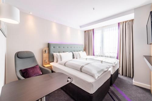 a hotel room with a bed and a desk at Premier Inn Köln City Süd in Cologne