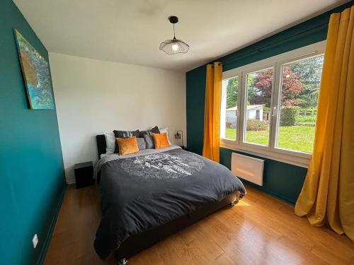 a bedroom with a bed and a large window at Maison cosy à Meaulne-Vitray avec jardin in Meaulne