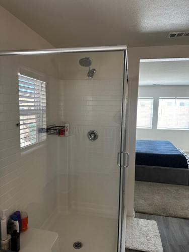 a bathroom with a shower and a bed at Beautiful New Build by Coachella Fest in Coachella