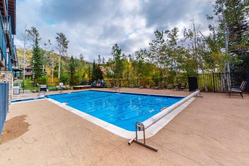 a large swimming pool in the middle of a yard at Scandinavian Lodge 203 in Steamboat Springs