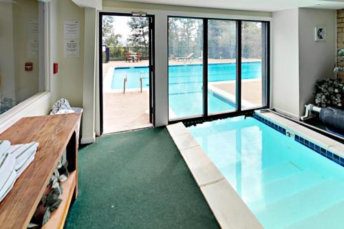 a large swimming pool with a view of a pool at Scandinavian Lodge 203 in Steamboat Springs