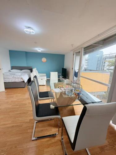 a room with a table and chairs and a bed at City Center Balcony by the Universities in Manchester