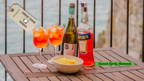 a table with two glasses and a bottle of wine at Il Sogno di Beatrice in Manarola