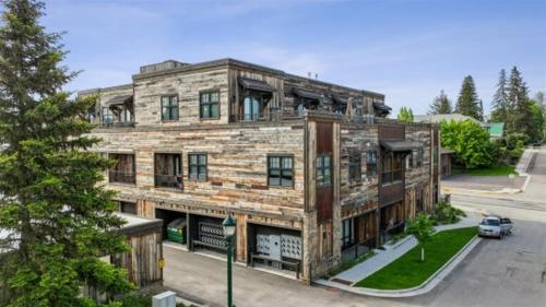 a brick building with a car parked in front of it at 2nd Street Lofts 209 in Whitefish