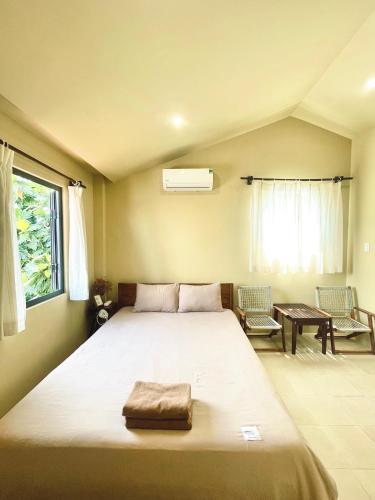 a bedroom with a large bed in a room at Biển house in Ấp Khánh Phước (1)
