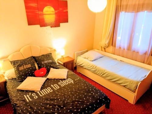 a hotel room with two beds and a window at Scandi-house in Marly-la-Ville