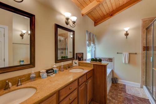 a bathroom with two sinks and a large mirror at Sugar Rush in Sugar Mountain
