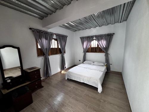 a bedroom with a bed and a dresser and a mirror at Villa del Atardecer Caribeño - JhonLimar in Bocachica