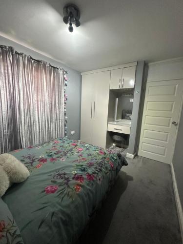 a bedroom with a bed with flowers on it at Midnight Stays in Manchester