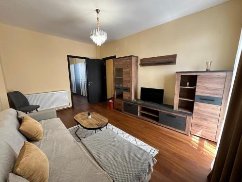 ein Wohnzimmer mit Sofa und Fernseher in der Unterkunft Kutaisi Apartment 54 in Kutaissi
