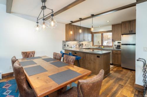 a kitchen with a wooden table and chairs at Riverside A101 - Riverside Hummingbird in Telluride