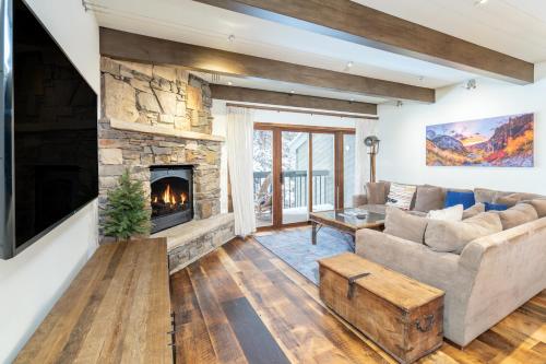 a living room with a couch and a fireplace at Riverside A101 - Riverside Hummingbird in Telluride