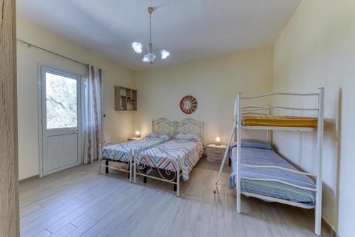 a bedroom with two bunk beds and a window at Villa Elena in Marina di Pescoluse