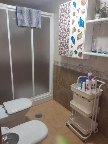 a bathroom with a toilet and a sink at APARTAMENTO EL TIMON in Carboneras