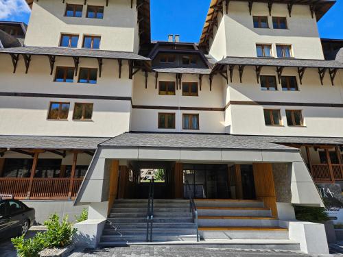 a building with a staircase leading to the front door at VujSki - Gondola Apartman in Brzeće