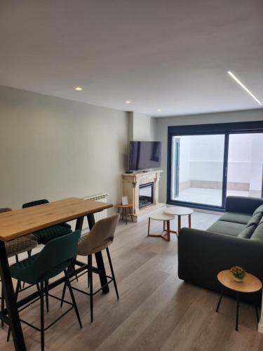 a living room with a table and a couch at CREDENCIAL Bulevar in Sarria