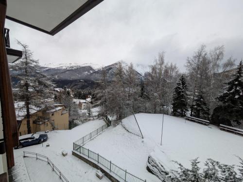 a view of a snow covered slope with a mountain at Natalia in Sauze d'Oulx