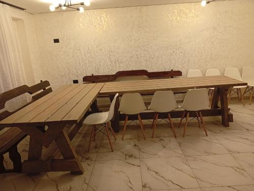a large wooden table in a room with chairs at Ехо Тростяну in Slavske