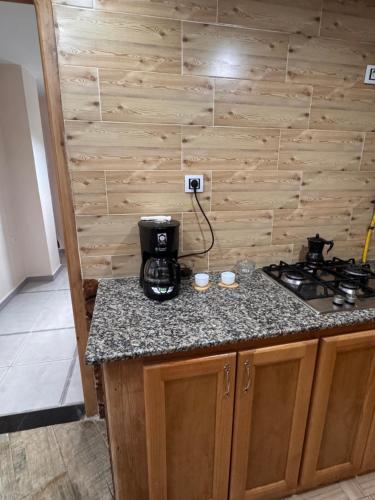 a kitchen with a stove and a counter top at Le Relax, Dellys 