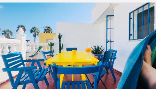 a yellow table and chairs on a balcony at CASA DEL SOL for 6 Persons-Almeria-Costacabana Seaview in Almería